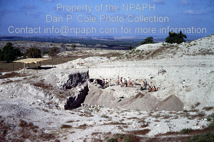Fld I; Teams digging occupation layers inside MB city wall at left; mid-morning shade-break shed outside wall. (1969, ID: cColepGezer083, Source: slide, Repository: NPAPH-project, Creator(s): Dan P. Cole)