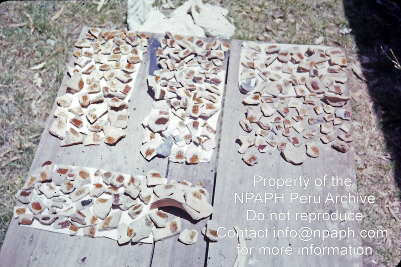 Potsherds collected at surveyed sites marked for identification by geographic location. The varnish protecting the ink is drying in the sun (1975-1976; ID: cTugenpPeru0240; Source: slide; Depository: NPAPH; Creator: Philip Tugendrajch)
